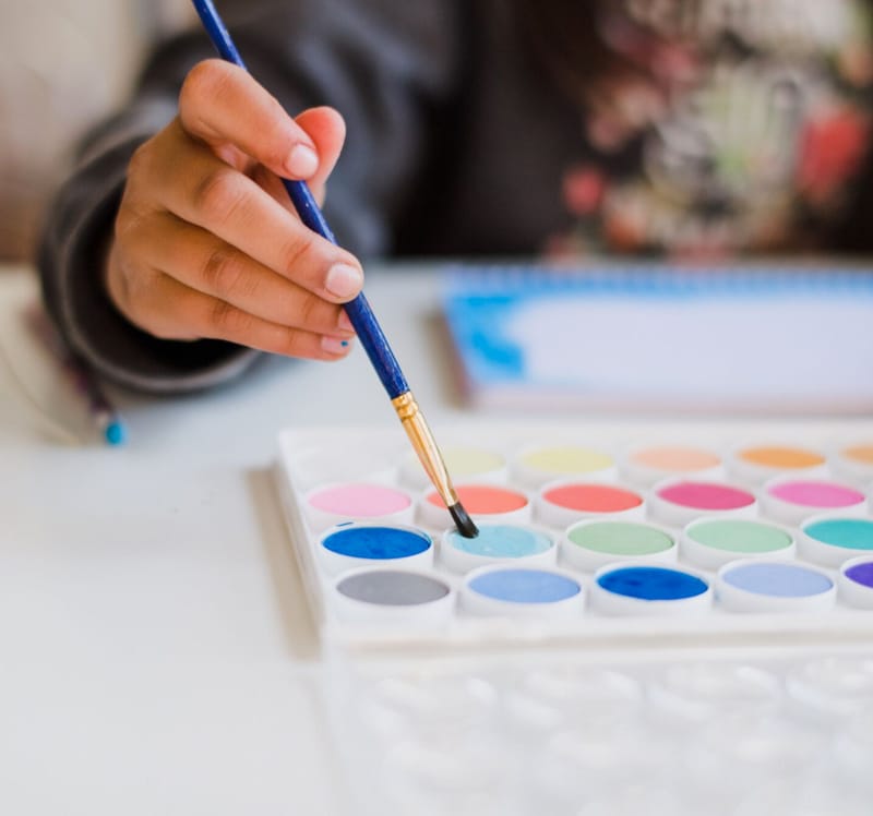 Child painting with watercolors