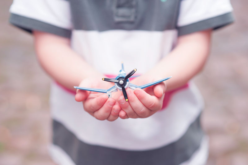 Small hands holding a paper crane
